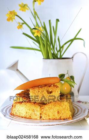 Carrot cake with a decorative carrot in front of daffodils View Large Photo Image Stock Photo - Carrot cake with a decorative carrot in front of daffodils. Fotosearch