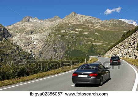 "Cars driving on the Furka Pass, the almost ice-free bed of the Rhone Glacier on the left, Belvedere Hotel in the centre, Gletsch, canton of Valais, Switzerland, Europe" View Large Photo Image Stock Photo - "Cars driving on the Furka Pass, the almost ice-free bed of the Rhone Glacier on the left, Belvedere Hotel in the centre, Gletsch, canton of Valais, Switzerland, Europe". Fotosearch