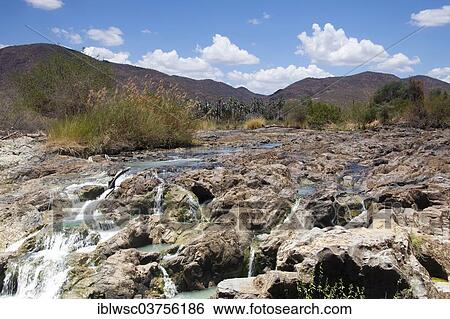 "Cascades of the Epupa Falls, formed by the Kunene River directly on the Angolan border, about 40 m, Epupa, Kaokoland, Kunene, Namibia, Africa" View Large Photo Image Stock Photograph - "Cascades of the Epupa Falls, formed by the Kunene River directly on the Angolan border, about 40 m, Epupa, Kaokoland, Kunene, Namibia, Africa". Fotosearch