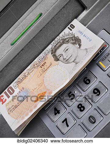 Stock Image - "Cashpoint dispensing cash, United Kingdom, Europe". Fotosearch