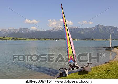 "Catamaran and boats on Lake Forggen, Fussen, Allgau, Upper Bavaria, Bavaria, Germany, Europe" View Large Photo Image Picture - "Catamaran and boats on Lake Forggen, Fussen, Allgau, Upper Bavaria, Bavaria, Germany, Europe". Fotosearch