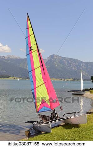 "Catamaran on Lake Forggen, Fussen, Allgau, Upper Bavaria, Bavaria, Germany, Europe" View Large Photo Image Stock Photography - "Catamaran on Lake Forggen, Fussen, Allgau, Upper Bavaria, Bavaria, Germany, Europe". Fotosearch