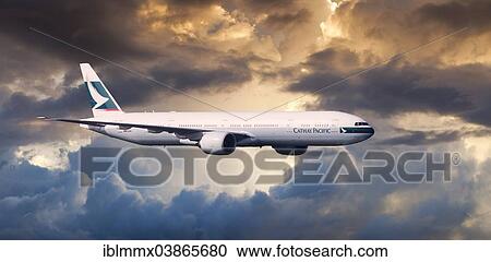 Cathay Pacific Boeing 777-367 ER in flight in the evening light View Large Photo Image Stock Image - Cathay Pacific Boeing 777-367 ER in flight in the evening light. Fotosearch
