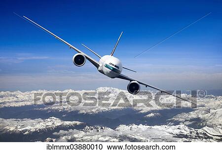 Stock Image - Cathay Pacific Boeing 777-367 ER in flight over mountains. Fotosearch