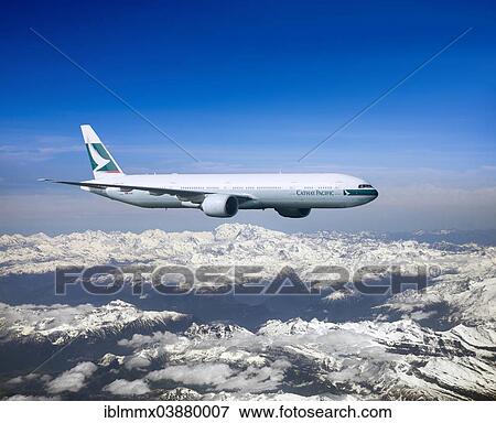 Cathay Pacific Boeing 777-367 ER in flight over mountains View Large Photo Image Stock Photo - Cathay Pacific Boeing 777-367 ER in flight over mountains. Fotosearch