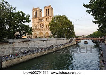 Stock Image - "Cathedral Notre-Dame de Paris in the last evening light, on the Ile de la Cite and the Seine, Paris, Ile-de-France, France, Europe". Fotosearch