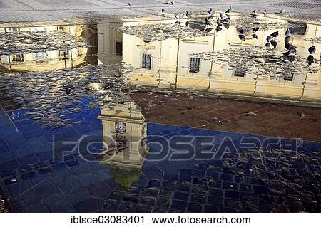 Stock Image - "Catholic Garrison Church reflected in play of water at the Grand Square, historic center, Sibiu, Transylvania, Romania, Europe". Fotosearch