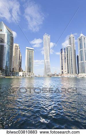 Stock Image - "Cayan Tower and skyscrapers with marina, Dubai Marina, Dubai, United Arab Emirates, Asia". Fotosearch