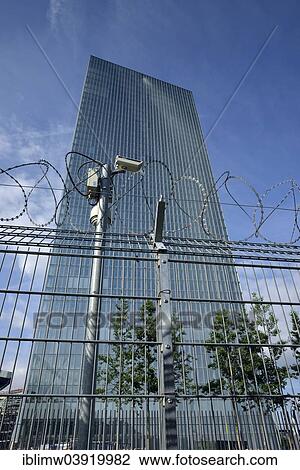 "CCTV camera, barbed wire fence, the new building of the European Central Bank, ECB, Ostend, Frankfurt am Main, Hesse, Germany, Europe" View Large Photo Image Stock Image - "CCTV camera, barbed wire fence, the new building of the European Central Bank, ECB, Ostend, Frankfurt am Main, Hesse, Germany, Europe". Fotosearch