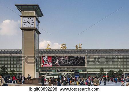 Stock Photo - "Central Station with clock tower and people in front of the entrance, Shanghai, China, Asia". Fotosearch