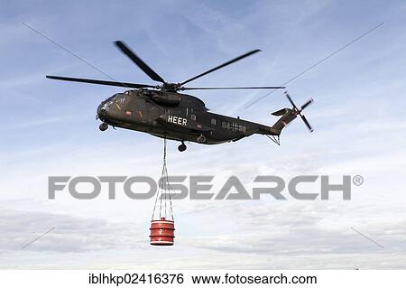 CH-53 helicopter carrying a 5000-liter water tank during an exercise, Laupheim, Baden-Wuerttemberg, Germany, Europe View Large Photo Image Stock Photograph - CH-53 helicopter carrying a 5000-liter water tank during an exercise, Laupheim, Baden-Wuerttemberg, Germany, Europe. Fotosearch