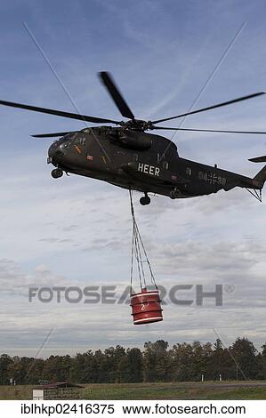 CH-53 helicopter carrying a 5000-liter water tank during an exercise, Laupheim, Baden-Wuerttemberg, Germany, Europe View Large Photo Image Stock Photography - CH-53 helicopter carrying a 5000-liter water tank during an exercise, Laupheim, Baden-Wuerttemberg, Germany, Europe. Fotosearch