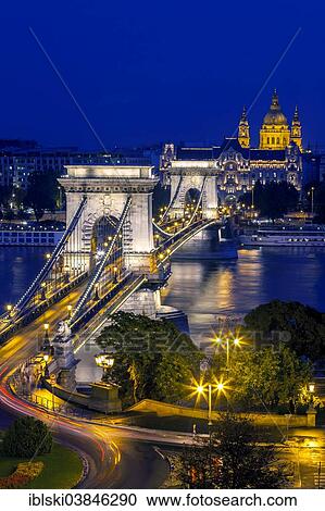 Stock Image - "Chain Bridge with St. Stephen's Basilica at the blue hour, Budapest, Hungary, Europe". Fotosearch