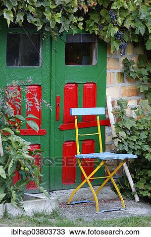 "Chair in front of a brightly painted door, Ahrenshoop, Fischland-Darss-Zingst, Mecklenburg-Vorpommern, Germany, Europe" View Large Photo Image Stock Image - "Chair in front of a brightly painted door, Ahrenshoop, Fischland-Darss-Zingst, Mecklenburg-Vorpommern, Germany, Europe". Fotosearch