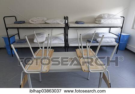 Stock Photo - "Chairs on a table, bunk beds, container accommodation for asylum seekers, Geretsried, Upper Bavaria, Bavaria, Germany, Europe". Fotosearch