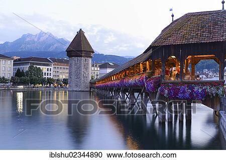"Chapel Bridge decorated with flowers and water tower, Lucerne, Switzerland, Europe" View Large Photo Image Stock Image - "Chapel Bridge decorated with flowers and water tower, Lucerne, Switzerland, Europe". Fotosearch