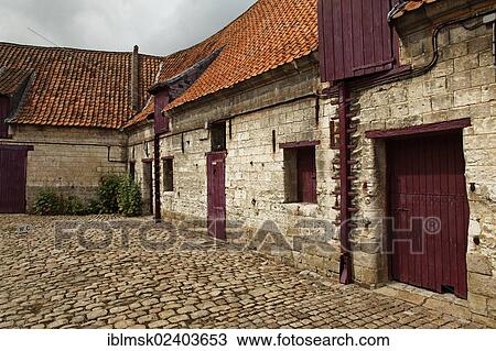 Stock Image - "Chateau de Olhain, courtyard of the moated castle, Olhain, Bruay-la-Buissiere, Via Francigena, Pas-de-Calais department, North Pas-de-Calais region, France, Europe". Fotosearch