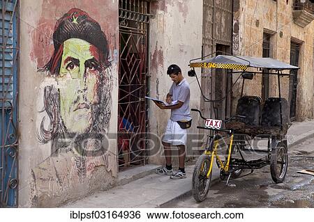 Stock Photograph - "Che Guevara mural and a pedicab in the historic town centre, Havana, Cuba, North America". Fotosearch