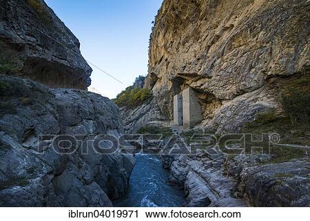 Stock Image - "Chechen watchtowers under overhanging cliff on the Argun river, near Itum Kale, Chechnya, Caucasus, Russia, Europe". Fotosearch