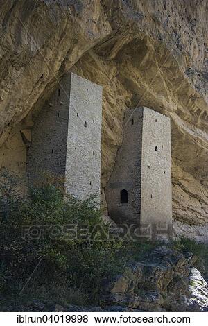 Stock Photo - "Chechen watchtowers under overhanging cliff on the Argun river, near Itum Kale, Chechnya, Caucasus, Russia, Europe". Fotosearch