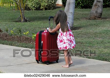 "Checking-out, little girl pushing a large suitcase, Caya Coco, Cuba, Greater Antilles, Caribbean, Central America, America, North America" View Large Photo Image Stock Photograph - "Checking-out, little girl pushing a large suitcase, Caya Coco, Cuba, Greater Antilles, Caribbean, Central America, America, North America". Fotosearch