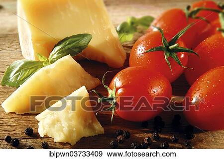 Stock Photo - Cheddar cheese and fresh tomatoes. Fotosearch