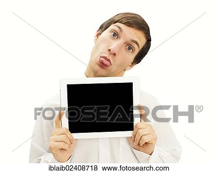 Stock Photo - Cheeky man sticking out his tongue holding an iPad. Fotosearch