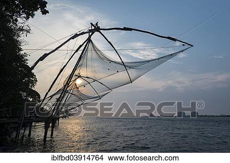 Picture - "Cheena vala or Chinese fishing nets in the evening, Fort Kochi, Kochi, Kerala, India, Asia". Fotosearch