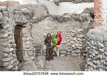 "Cheerful children in a village between old walls, ethnic group of Lopa, Charang, Lo or Mustang, Nepal, Asia" View Large Photo Image Stock Photo - "Cheerful children in a village between old walls, ethnic group of Lopa, Charang, Lo or Mustang, Nepal, Asia". Fotosearch