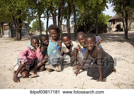 Stock Image - "Cheerful children in a village in the Okavango Delta, Botswana, Africa". Fotosearch