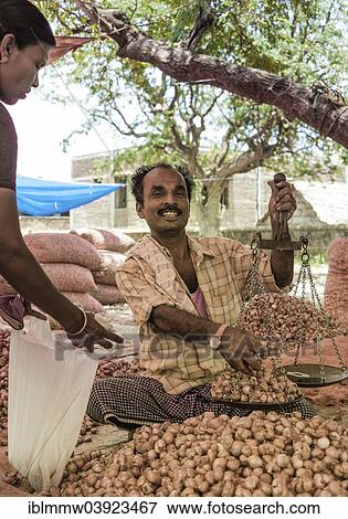 "Cheerful vendor holding scales, Indian market, Chinnamanur, Tamil Nadu, India, Asia" View Large Photo Image Stock Photo - "Cheerful vendor holding scales, Indian market, Chinnamanur, Tamil Nadu, India, Asia". Fotosearch