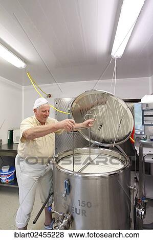 Stock Photo - "Cheesemaker during the production of goat cheese at the Goas-Alm cheese factory, Goas-Alm, Mittenwald, Upper Bavaria, Bavaria, Germany, Europe". Fotosearch