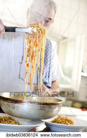 Picture - "Chef dishing up spaghetti, Italian restaurant, Munich, Upper Bavaria, Bavaria, Germany, Europe". Fotosearch