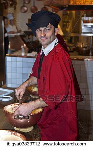 Stock Image - "Chef preparing the traditional omelette mixture in copper bowls, in the restaurant La Mere Poulard, Mont Saint-Michel, Le Mont-Saint-Michel, Normandy, France, Europe". Fotosearch