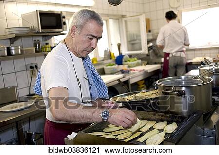 "Chef roasting aubergines for an antipasti dish, Italian restaurant, ristorante, Munich, Upper Bavaria, Bavaria, Germany, Europe" View Large Photo Image Stock Image - "Chef roasting aubergines for an antipasti dish, Italian restaurant, ristorante, Munich, Upper Bavaria, Bavaria, Germany, Europe". Fotosearch