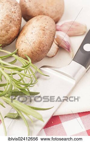 Chestnut mushrooms, rosemary and kitchen knife on a cutting board View Large Photo Image Stock Photograph - Chestnut mushrooms, rosemary and kitchen knife on a cutting board. Fotosearch