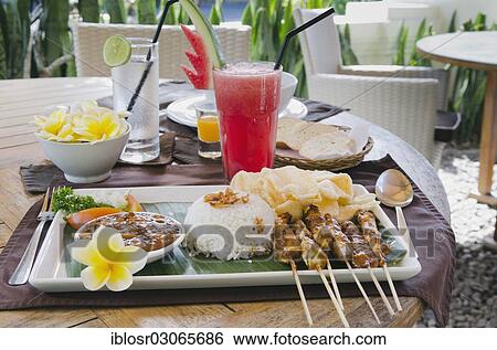 Stock Photograph - "Chicken satay, chicken skewers with rice, Indonesian cuisine, at a restaurant, Ubud, Bali, Indonesia, Asia". Fotosearch
