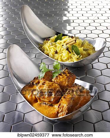 Stock Photo - "Chicken Tikka Masala with Pilau rice and naan bread, Indian food". Fotosearch