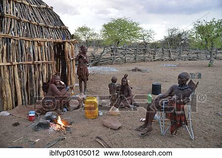 "Chief Hikuminue Kapika, chief of the Namibian Himba, with his family at the fire in his kraal, Omuramba, Kaokoland, Kunene, Namibia, Africa" View Large Photo Image Stock Image - "Chief Hikuminue Kapika, chief of the Namibian Himba, with his family at the fire in his kraal, Omuramba, Kaokoland, Kunene, Namibia, Africa". Fotosearch