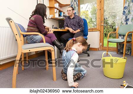 "Child playing with toys while her mother talks to a GP doctor, United Kingdom, Europe" View Large Photo Image Stock Image - "Child playing with toys while her mother talks to a GP doctor, United Kingdom, Europe". Fotosearch