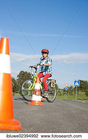 Child practicing to ride slalom on a bicycle at a traffic awareness course View Large Photo Image Stock Image - Child practicing to ride slalom on a bicycle at a traffic awareness course. Fotosearch