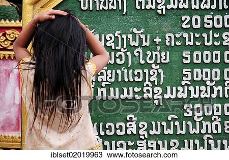 "Child reading Asian lettering, hands on her head, Laos, Southeast Asia, Asia" View Large Photo Image Stock Image - "Child reading Asian lettering, hands on her head, Laos, Southeast Asia, Asia". Fotosearch