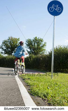 Stock Photo - Child riding a bicycle at a traffic awareness course. Fotosearch