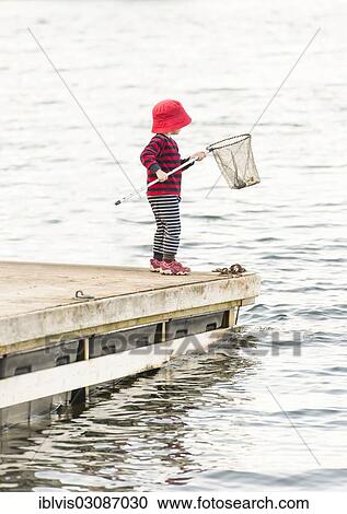 "Child standing on jetty, holding dip net, Stockholm, Stockholm County, Sweden, Europe" View Large Photo Image Stock Image - "Child standing on jetty, holding dip net, Stockholm, Stockholm County, Sweden, Europe". Fotosearch