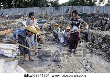 "Children and teenagers mix concrete on a high rise construction site, Mandalay, Myanmar, Asia" View Large Photo Image Stock Image - "Children and teenagers mix concrete on a high rise construction site, Mandalay, Myanmar, Asia". Fotosearch