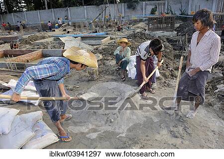 "Children and teenagers mix concrete on a high rise construction site, Mandalay, Myanmar, Asia" View Large Photo Image Stock Photo - "Children and teenagers mix concrete on a high rise construction site, Mandalay, Myanmar, Asia". Fotosearch