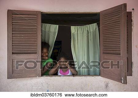 Stock Photograph - "Children at the window of a house, Rui Vaz, Santiago, Cape Verde, Africa". Fotosearch