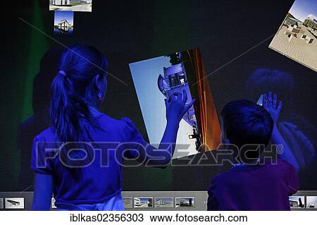 Stock Image - "Children controlling software by touch and gestures, touch screen, Ideenpark 2012, technology and education summit conference, Essen, Ruhr area, North Rhine-Westphalia, Germany, Europe". Fotosearch