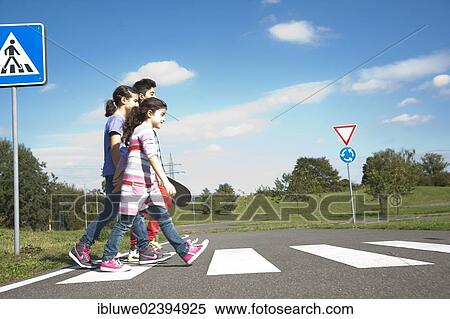 Stock Photography - Children crossing a zebra crossing. Fotosearch