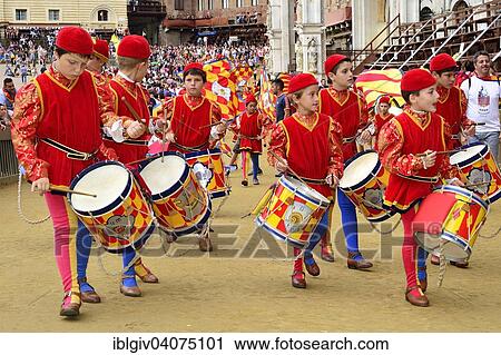 Stock Image - "Children drumming group of the Contrada of the Snail, Contrada della Chiocciola, at the Palio di Siena, Piazza del Campo, Siena Tuscany, Italy, Europe". Fotosearch